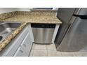 Close-up of a stainless steel dishwasher in a kitchen with granite countertops at 6311 W Washington Ave, Las Vegas, NV 89107