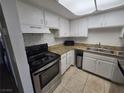 A kitchen with white cabinets, granite countertops, and stainless steel appliances at 6311 W Washington Ave, Las Vegas, NV 89107