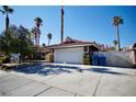 Home's exterior features a white garage door and a paved driveway at 7393 Puritan Ave, Las Vegas, NV 89123