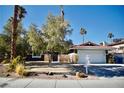 House exterior showcasing a front yard, garage, and landscaping at 7393 Puritan Ave, Las Vegas, NV 89123