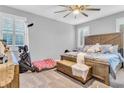 Spacious bedroom with a large bed, ceiling fan, and plenty of natural light at 145 Langley Hill Ave, Henderson, NV 89002