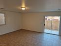 Living room with tile floors and sliding glass doors at 3367 Villa Fiori Ave, Las Vegas, NV 89141