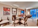 Dining area with a round glass table and four chairs, near the living room at 145 E Harmon Ave # 2321, Las Vegas, NV 89109