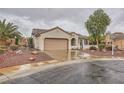 Attractive single-story home with tile roof, two-car garage, desert landscaping and mature palm tree at 3005 Noblesville Ct, Henderson, NV 89052