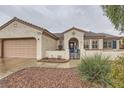 Inviting single-story home with tile roof, two-car garage and desert landscaping for easy maintenance at 3005 Noblesville Ct, Henderson, NV 89052