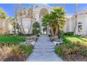 Elegant home entrance with stairs and lush landscaping at 8109 Moonstone Cir, Las Vegas, NV 89128