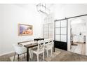 Dining room with a sliding barn door and kitchen access at 841 Glitter Glen Ct, Las Vegas, NV 89123