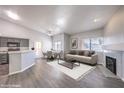 Open living area with gray flooring and a staged fireplace at 900 Heavenly Hills Ct # 217, Las Vegas, NV 89145