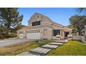 Two-story house with a three-car garage and landscaped yard at 2645 Douglas Cir, Henderson, NV 89074