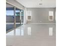 Spacious living room with sliding glass doors and large light tile flooring throughout at 3408 Isle Dr, Las Vegas, NV 89141