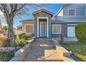 Front entrance with stone steps leading to a covered porch at 6019 Orca Lilly St, North Las Vegas, NV 89031