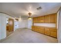 Spacious dining area featuring wood cabinets and a light chandelier at 1911 S Vineyard Dr, Pahrump, NV 89048