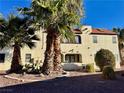 Two-story condo building with palm trees and desert landscaping on a sunny day at 6137 W Oakey Blvd # A, Las Vegas, NV 89146