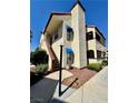 Two story condo featuring neutral tone stucco, private entrance stairs, and well maintained landscaping at 6137 W Oakey Blvd # A, Las Vegas, NV 89146