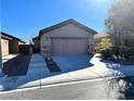 Front view of a single-story house with a two-car garage at 4021 Gliding Gulls Ave, North Las Vegas, NV 89084