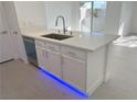 Kitchen island featuring stainless steel sink, modern faucet and white cabinets at 7255 W Sunset Rd # 2046, Las Vegas, NV 89113