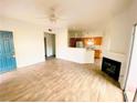 Open living room with tile floors and kitchen with breakfast bar at 2100 Black Island St # 101, Las Vegas, NV 89128