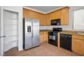 Efficient kitchen featuring stainless steel refrigerator, gas range, microwave, and light wood cabinets at 3652 Remington Grove Ave, North Las Vegas, NV 89081
