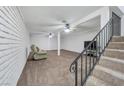 Finished basement with neutral carpeting and ceiling fan at 5145 Tennis Ct, Las Vegas, NV 89120