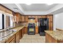 Kitchen features wood cabinets and granite countertops at 5145 Tennis Ct, Las Vegas, NV 89120