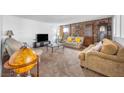 Spacious living room with stone fireplace and comfy seating at 5145 Tennis Ct, Las Vegas, NV 89120