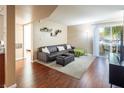 Comfortable living room featuring a plush sofa, sliding door access to balcony, and stylish decor at 2120 Ramrod Ave # 1112, Henderson, NV 89014