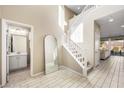 Bright entryway with tile floors, half bathroom, and staircase at 3094 Isle Dr, Las Vegas, NV 89141