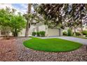Charming single-Gathering home with a two-car garage, concrete driveway, and mature trees at 3146 Bel Air Dr, Las Vegas, NV 89109