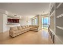 Living room with a sectional sofa and kitchen peek at 9101 Alta Dr # 1204, Las Vegas, NV 89145