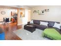 Living room with L-shaped sofa, wood floors, and kitchen view at 2120 Ramrod Ave # 1112, Henderson, NV 89014
