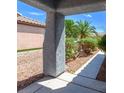 Covered porch provides shade and a glimpse of the home's desert landscape at 3591 Driving Range St, Las Vegas, NV 89122