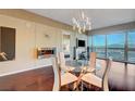 Modern dining area with glass table and chairs, fireplace, and city views at 4471 Dean Martin Dr # 3908, Las Vegas, NV 89103