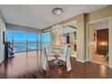 Open concept dining area with glass table, modern chandelier, and city views at 4471 Dean Martin Dr # 3908, Las Vegas, NV 89103