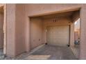 Attached carport with tan walls, brick paving and neutral colored door at 177 Almond Ridge Pl, Henderson, NV 89015