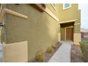 Close up of front door with trimmed shrubbery and neutral paint scheme at 4920 Blue Rose St, North Las Vegas, NV 89081