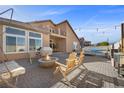 Inviting backyard with a fire pit, lounge area, and outdoor seating at 5944 Vizzi Ct, Las Vegas, NV 89131