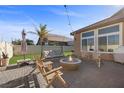 Charming backyard featuring a cozy fire pit and comfortable seating at 5944 Vizzi Ct, Las Vegas, NV 89131