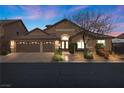 Beautiful home exterior with a three-car garage and well-manicured landscaping at 5944 Vizzi Ct, Las Vegas, NV 89131