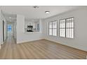 Bright living room with light wood flooring and modern kitchen views at 6776 Arroyo Ave, Las Vegas, NV 89103