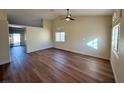 Open living room with hardwood floors and access to other rooms at 1144 Kabuki Ave, Henderson, NV 89074