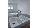 Close up shot of a kitchen with an updated sink with tile backsplash and granite countertops at 1381 E University Ave # 102, Las Vegas, NV 89119