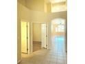 Open hallway showcases arched doorways and tile flooring transitioning to carpet and hardwood at 5048 Orchid Springs St, Las Vegas, NV 89148