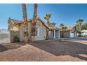 Single-story home with a large yard, mature palm trees, and a detached garage at 3245 W Landberg Ave, Las Vegas, NV 89141