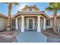 Elegant home entrance with a grand entryway and stone walkway at 3245 W Landberg Ave, Las Vegas, NV 89141