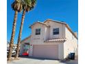 Two-story house with a pink garage door and two palm trees at 5402 Night Swim Ln, Las Vegas, NV 89113