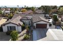 Single-story house with a two-car garage and nicely landscaped yard at 8229 Flowing Rapids Ct, Las Vegas, NV 89131