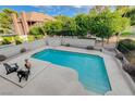 Backyard boasts a refreshing pool surrounded by a patio, perfect for relaxation and entertaining with lush landscaping at 945 Vegas Valley Dr, Las Vegas, NV 89109