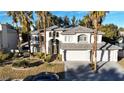 Two-story house with grey roof, three-car garage, and palm trees at 10008 Rolling Glen Ct, Las Vegas, NV 89117