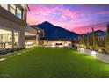 Expansive backyard oasis with fire pit and mountain views at 11250 Torch Cactus Dr, Las Vegas, NV 89138