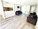 Bright living room with gray floors and comfy sofas at 2831 Geary Pl # 2921, Las Vegas, NV 89109